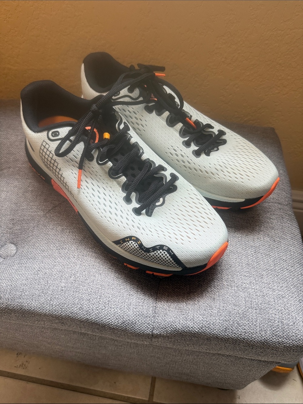 Under Armour Men's White and Black Running Sneakers with Orange Accents